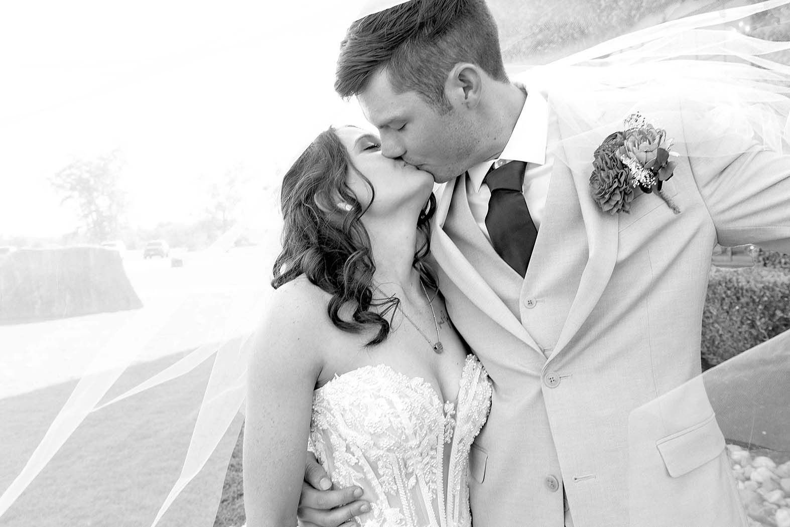 Bride and groom kiss at Olde Dobbin Station wedding venue