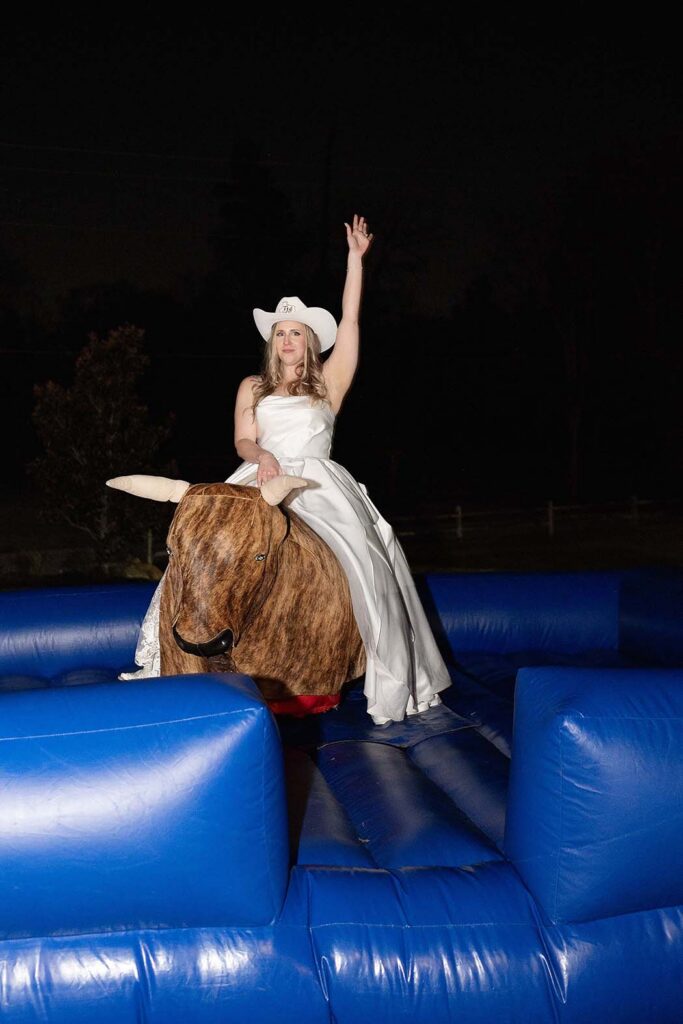 bride riding mechanical bull at texas wedding